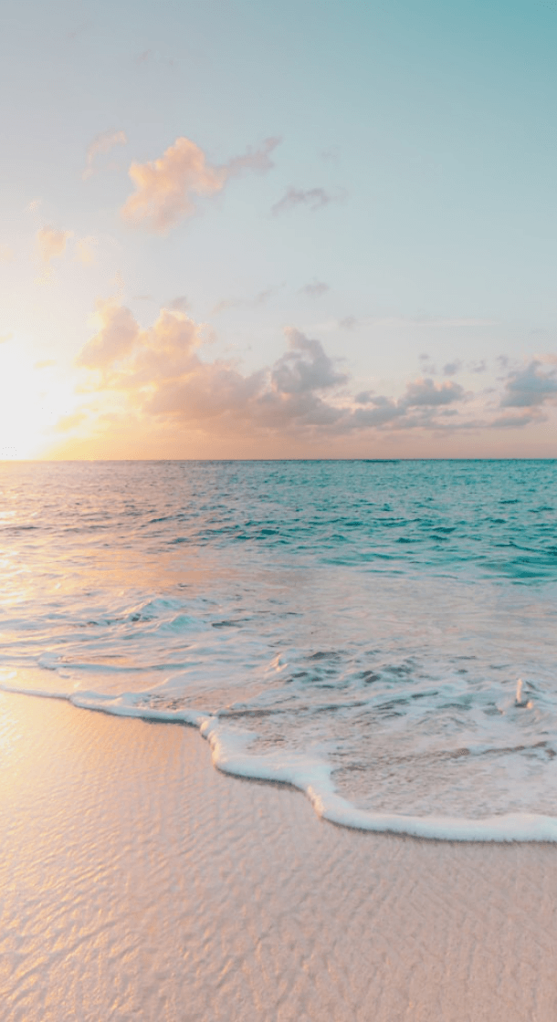 Golden hour over a pristine tropical beach with turquoise water